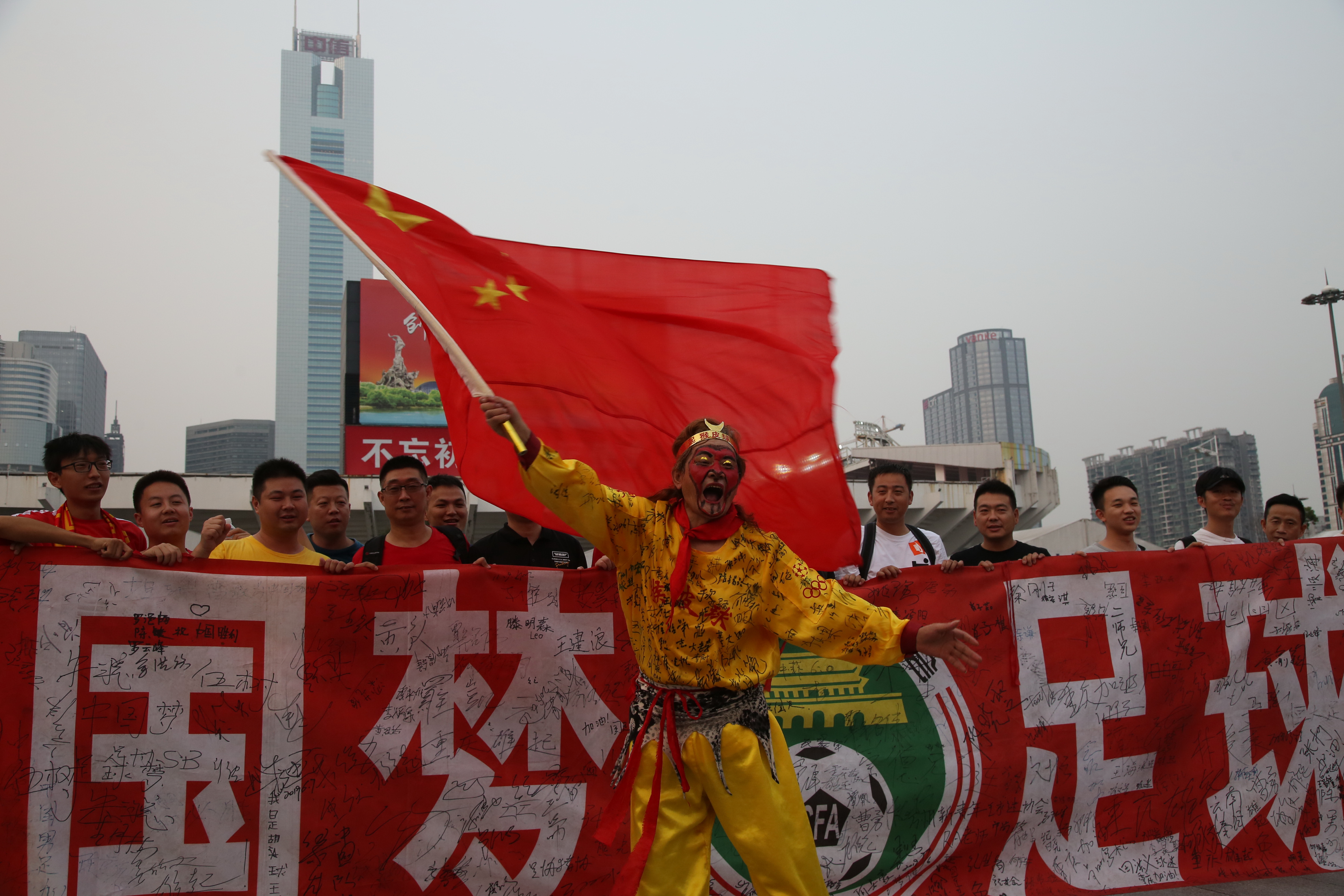 球迷疯狂挥舞国旗助威，场面热闹壮观